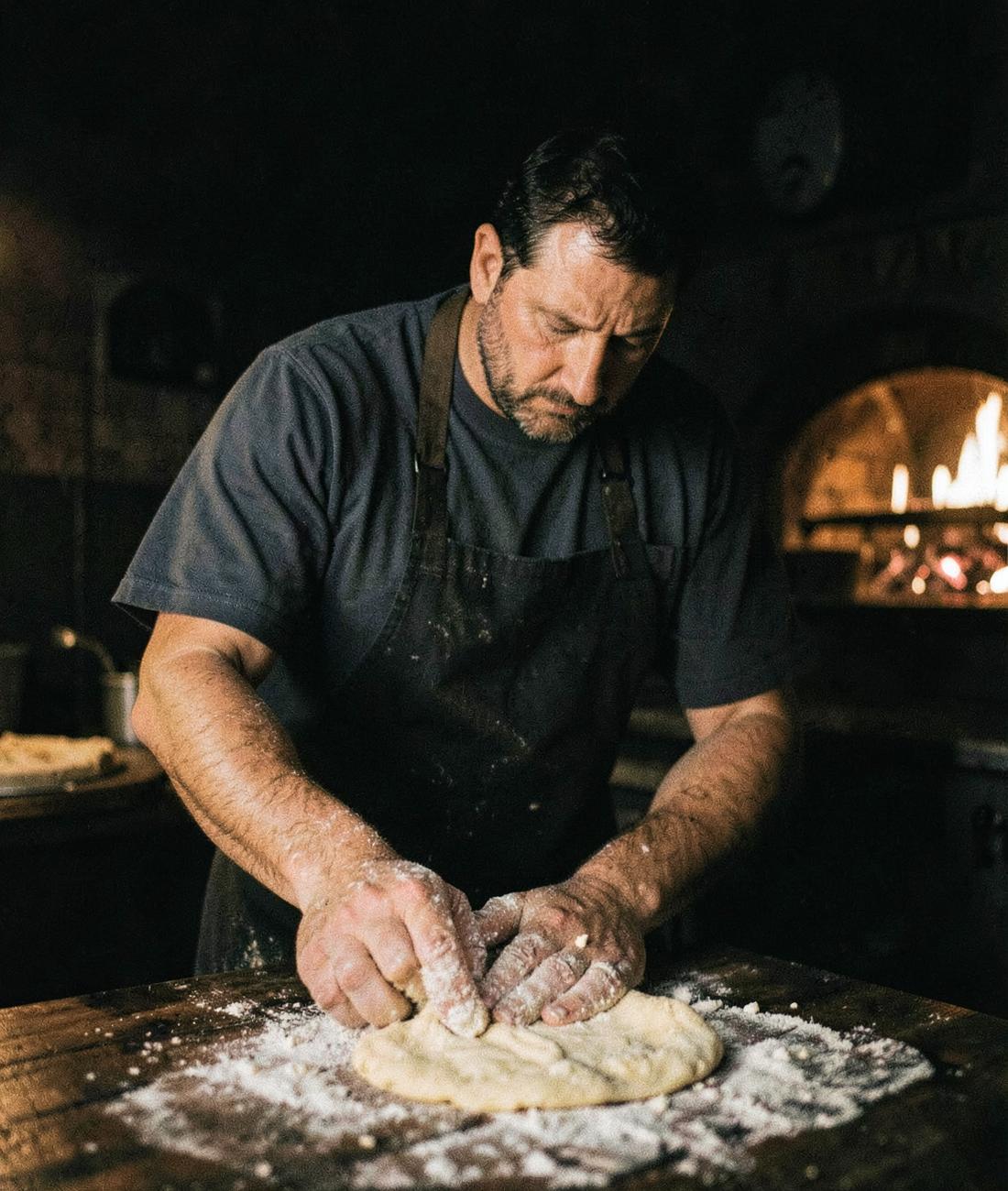 Vlad, Pizza chef, stretching dough by the wood oven
